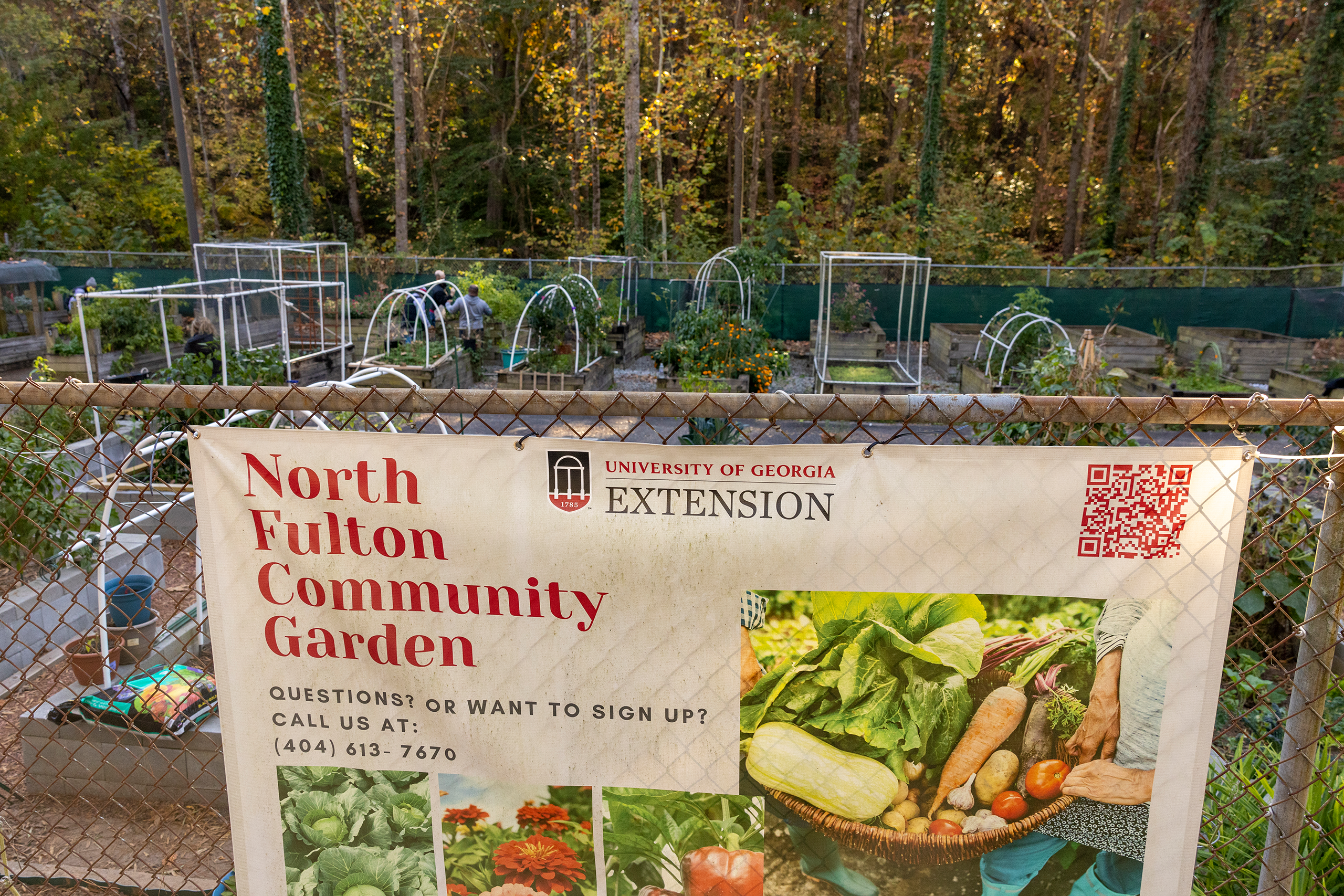 North Fulton Community Garden sign, with garden in background