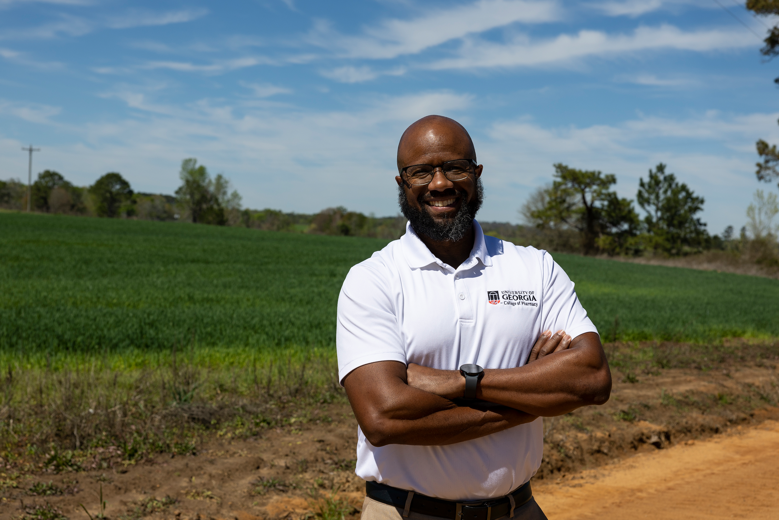 Dr. Henry Young standing near a field